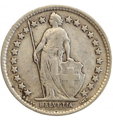 Avers : Helvetia debout vêtue d'une toge, appuyée contre un bouclier et tenant une lance