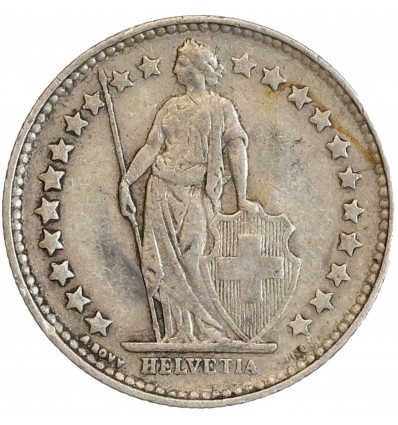 Avers : Helvetia debout vêtue d'une toge, appuyée contre un bouclier et tenant une lance