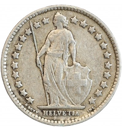 Avers : Helvetia debout vêtue d'une toge, appuyée contre un bouclier et tenant une lance