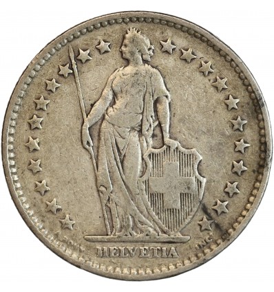 Avers : Helvetia debout vêtue d'une toge, appuyée contre un bouclier et tenant une lance