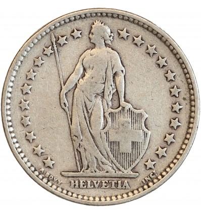 Avers : Helvetia debout vêtue d'une toge, appuyée contre un bouclier et tenant une lance