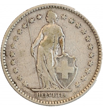 Avers : Helvetia debout vêtue d'une toge, appuyée contre un bouclier et tenant une lance