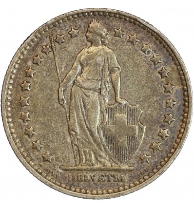 Avers : Helvetia debout vêtue d'une toge, appuyée contre un bouclier et tenant une lance