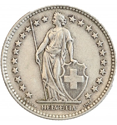 Avers : Helvetia debout vêtue d'une toge, appuyée contre un bouclier et tenant une lance